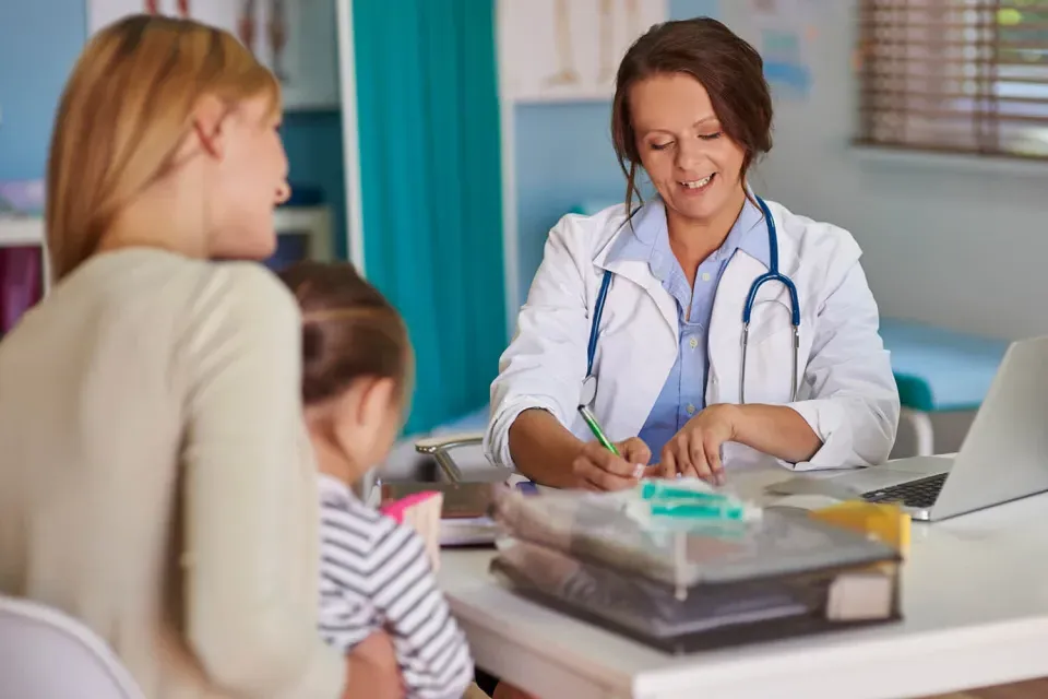 Pediatric Primary Care Nurse Practitioner Diagnosing Child Patient